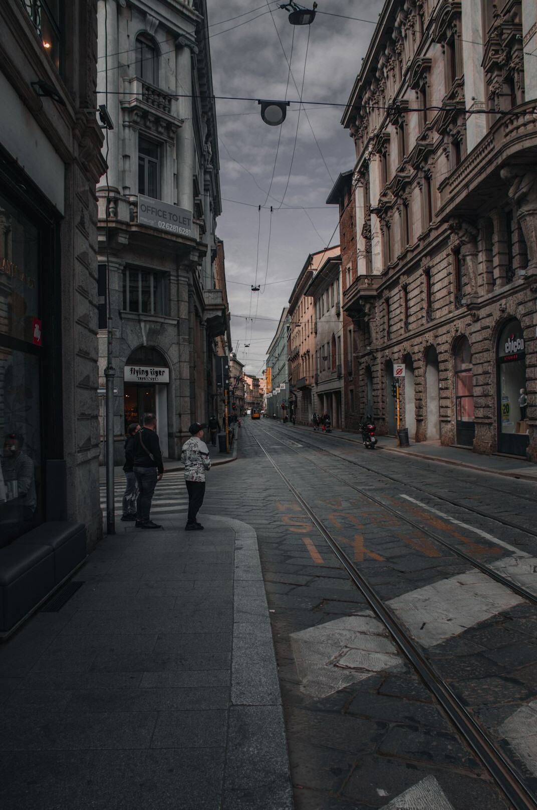 Photographer walking down a city street with a camera